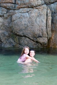 Taking a dip at the beach at the end of our road, a secret spot for locals. 4 and 7, back a few years..